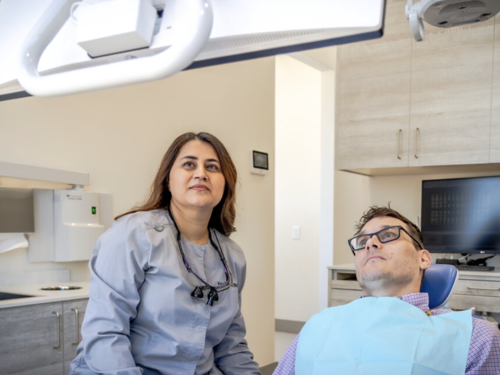 Dentist providing gentle patient care at Dental Wellness at Serenbe